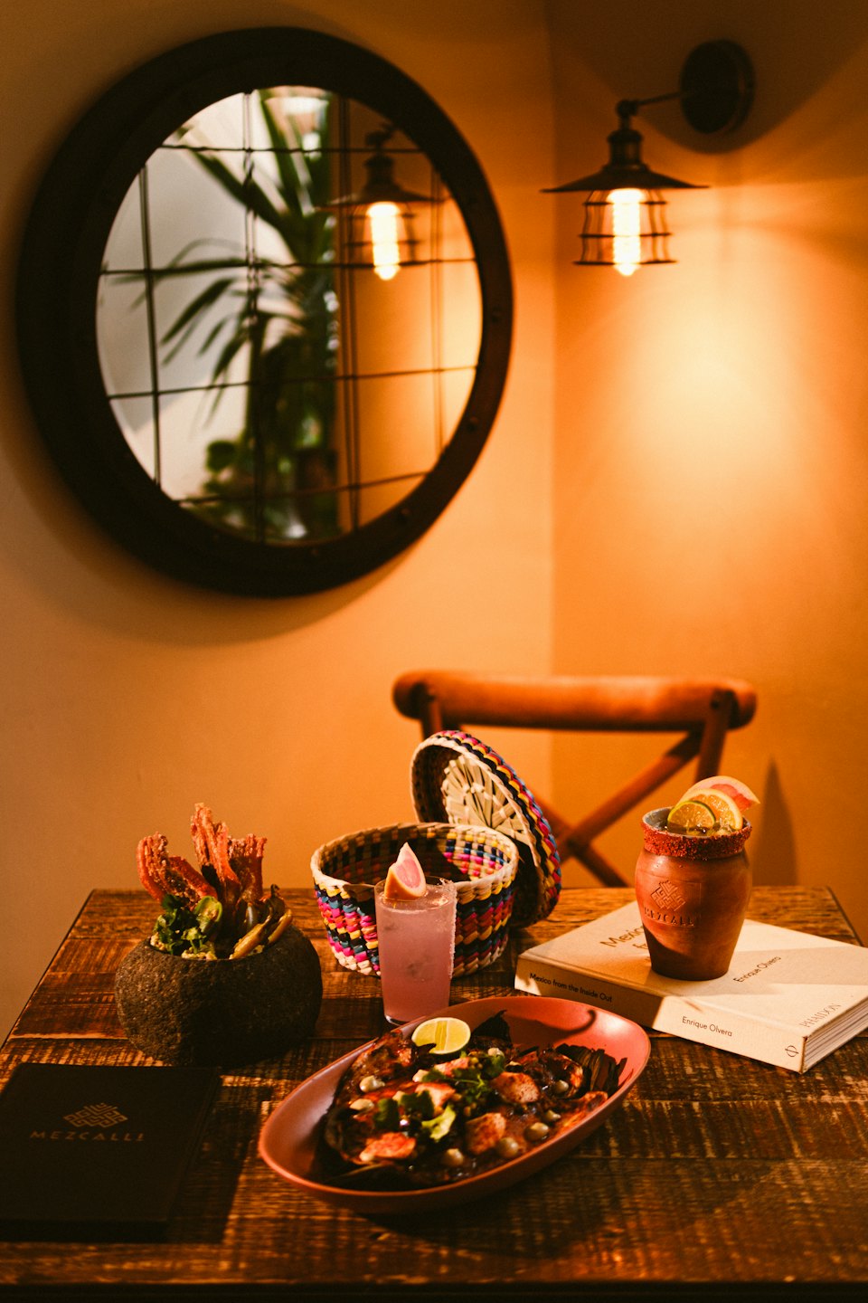 Grilled food and drinks on a rustic wooden table.