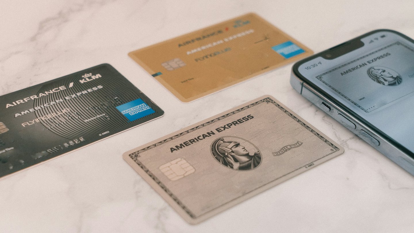 Credit cards and smartphone with digital card on marble.